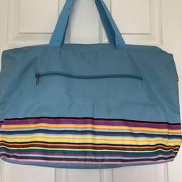 Lovely water resistant bag.  Mainly sky blue with splash of colourful stripes.  Large size with full width zip fastener.  Has a purse which is attached with a length of cord for safety.  Would be great for holidays or shopping.