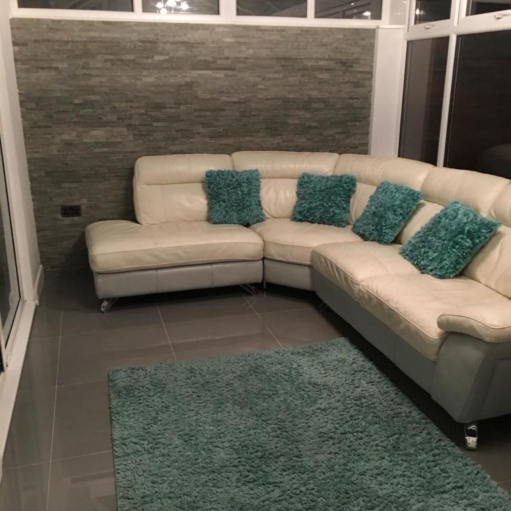 Large corner sofa with a matching swivel chair and foot stool, in good condition will need a clean, full leather in 2 tone white and light grey. Cost over £3500 new, collection only