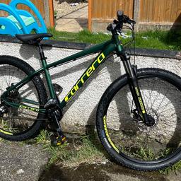 Carrera vengeance 18” mountain bike, 2 x 8 (16 speed gears ), disc breaks, original 27.5” kenda tyres. 1 year old and still in very good condition but due to constant use it does have some marks from break wires rubbing against the frame. Colour is a dark green with yellow stickers. Slight buckles in each wheel have been there since I brought a year ago as was good enough by Halfords. 