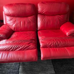Two seater red leather sofa that can be separated with reclining seats. Width 70”, height 41” and depth 38” all approximate.