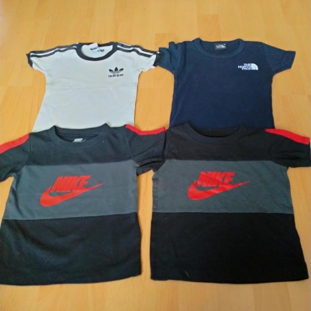 4. t shirts 2 Nike 1 Adidas 1 North face size 24 months