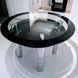 round double layer glass dining table. black & chrome. 110cm/43 inches wide. in good condition but does have some fine scratches on surface panel. glass panels are very heavy & may require two people to lift. it will be dismantled for collection.