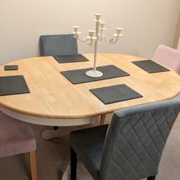 great condition extending dining table and 4 fabric chairs 2 grey 2 pink it's very heavy and a very nice table 120 Ono