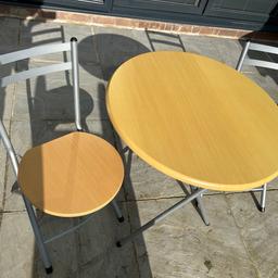 Bistro table 2 x chair set foldable indoor use only
#startfresh

Table diameter 69cm height approximately 80cm
Chairs are w36cm x l38cm
Slight scuff on side of table as shown in photo

Been used indoors only
