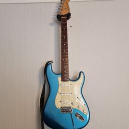This preloved Fender Stratocaster was built in Mexico and released in 2001. It plays very well and offers the signature Fender sound with its single coil pickups.
The body is made from poplar wood and the neck and headstock from white maple and rosewood. Has been serviced by a professional luthier and has new 10 gauage strings; comes with two paintwork chips on the body (see photos). Other than that, the structural integrity is good and it has no connectivity issues to amplifiers or noisy volume/tone pots. I personally have kept the fingerboard well lemon-oiled and keep all my guitars clean. Comes with equipped with a Fender Custom Shop shoulder strap, strap locks and a Gator hard case that has a small hole in it. £450 ONO; collection from my flat in Dudley