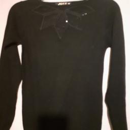 Pretty black jumper with cutout see through design with black slightly sparkling embellishments around the petal design.