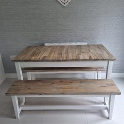 Wooden table with natural colour top and white legs. Comes with 2 benches and two chairs. Measures 140cms/75cms but does extend to approx 180cms.