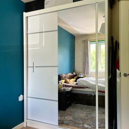 Glossy white sliding door mirrored wardrobe. Width: 150cm, Height: 215cm, Depth: 60cm