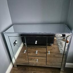 2 x mirrored glass sideboard cupboards in perfect condition apart from a crack on one of the doors, as you can see on the photo, from the side you can hardly notice it. These cost me £350 EACH. I am asking for £250 for both. Absolute bargain. Dimensions H 100cm D 40cm H 82cm. 
They do both have child proof edging on at the moment, that can be easily removed.
VERY heavy, will need 2 people to lift on collection.