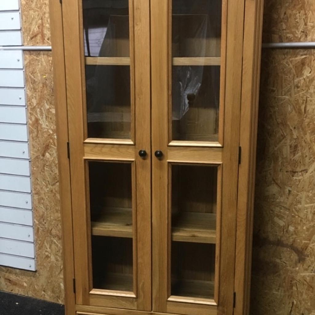 Solid oak display cabinet with large glass doors, 3 x fixed shelves inside and 2 x dovetail storage drawers at the bottom. A lovely piece of heavy, quality furniture built to last. The unit measures 92cm wide x 36cm deep x 190cm tall. Viewing/collection is Leeds LS24 & delivery is available if required - £250