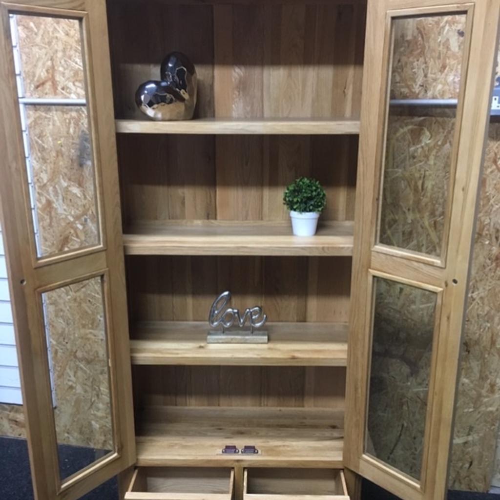 Solid oak display cabinet with large glass doors, 3 x fixed shelves inside and 2 x dovetail storage drawers at the bottom. A lovely piece of heavy, quality furniture built to last. The unit measures 92cm wide x 36cm deep x 190cm tall. Viewing/collection is Leeds LS24 & delivery is available if required - £250