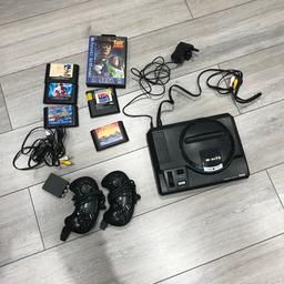 Sega games console with a few games and two controllers all the leads
