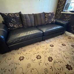 Black leather sofas. Have very small signs of wear and tear. Very high quality leather. Has reversible cushions. A plain side and floral side. two large 4 seater sofas and one 3 seater