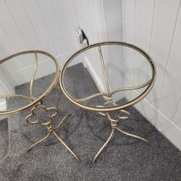 Two bedside tables gold coloured metal base with glass tops.
height 25inches
diameter 15 inches