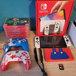 Nintendo oled 
11 games 
luigis mansion 
pikmin4
super Mario wonder 
super Mario odyssey 
little friends puppy island 
two point campus 
Mario kart 8 deluxe 
the legend of zelda 
Splatoon 3
animal crossing
hogwarts legacy (no case) just game card as lost the case 

comes with 2 wired controllers and
2 cases.