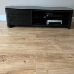 Alphason TV unit
Black wood 
Glass top and glass shelf
One small draw + one cupboard with drop down door 
Back panel has slots for cable management 

Measurements 
Length - 1360mm
Depth - 450mm
Height - 370mm

Excellent condition
From a non pet & no smoking home