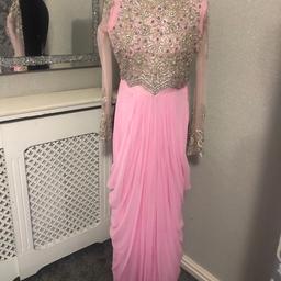 This is a tailor made dress


Listing is for dress only


Please see you tube video of the dress, link below


https://youtube.com/shorts/xQdVoESd2WU?si=Pfziq1OxfpGhRzdc



Suitable for Indian/Asian/Pakistani party wear


Would suit ladies size 4-6 or a teenager


Please see measurements below


Colour pink


Waterfall drape design


Rhinestone detail front and back - please note some stones/beadwork could be missing here and there or lose



Long sheer sleeves with beautiful rhinestone/beadwork


Zip fastening at back


Hook and eye fastening at back - hook missing


Used condition


As it’s a long dress there is black marks at the bottom of the dress but you can hardly tell when it’s on


Measurements - all Approx


Length 137cm


Shoulder 36cm


Armpit to armpit 40cm


Waist 33cm


Sleeves length 56cm


Armhole 17cm




I have another dress exactly like design this please see my other listings


Any questions please ask


Please see my other items for sale