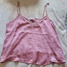 A satin pyjama top from Primark with signs of wear and staining on the front. Barely noticeable.