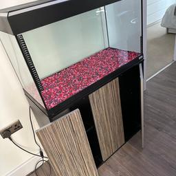 Fluval Roma 125L, everything is used but very good condition. 1 door of the cupboard is broke, but should be easy fix or can be used without it. Has Fluval underwater U3 filter, original lights with nearly new bulbs and additional multi coloured light with remote control, decorations, air stone, some fish food, spare filter parts and some other useful bits ( all in the picture), Marina multi coloured gravel included