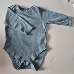 Turquoise baby vest.
worn but outgrown