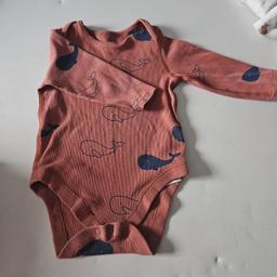 Coral baby vest.
Long sleeved with whale pattern 
worn but outgrown