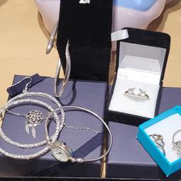 sterling silver bundle all new or like new their is rings a dream catcher bracelet a dolphin bangle a mum and heart necklace a large pair of cz hoop earrings and a bangle watch postage to be covered if needed plz thanks