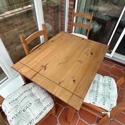 Pine table and 4 chairs and cushions for sale