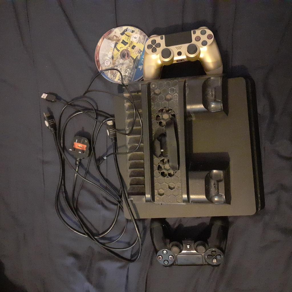 PS4 Slim 500GB Comes with all cables and is working perfectly fine.

Comes with 2 controllers, back button attachment (Doesn't work on the Gold controller) Also comes with Charging Dock

Also comes with 5 games including: Mortal Kombat X, Fifa 17, Fifa 18, Uncharted 4 and GTA 5

By the way I only accept CASH in person, no bank transfer no PayPal, no delivery, only CASH in person