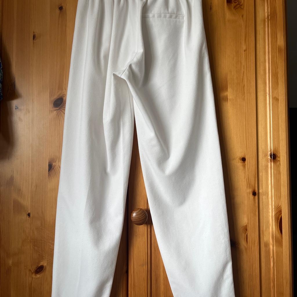 White tapered slim leg trousers with turn up Jean and side stripe, size Xtra Small by Bershka.
Worn but still in good condition.