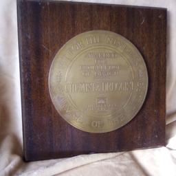 wooden board with solid brass award attached.for excellence in design. very very heavy. collect please from oxenhope Bradford 22