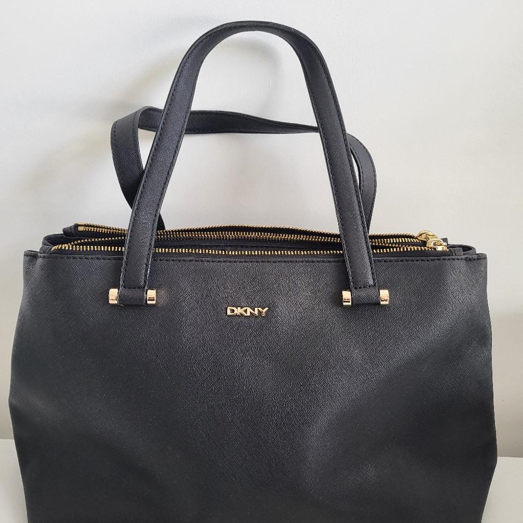 This beautiful leather original DKNY handbag is in great condition. It can fit a 14" laptop, various documents and a lot more! It has three very large compartments (two that can be closed with zip). Available with Dust Bag and original leather extension strap as pictured. Really nice structure and stitching, was originally about for £100+ so this is a bargain price for a smart, long lasting bag.

Height: 24cm (41cm with straps)
Width: 41cm

If bought, I will throw in a free Radley Red Leather Coin purse (pictured) which is brand new and has a dust bag too.