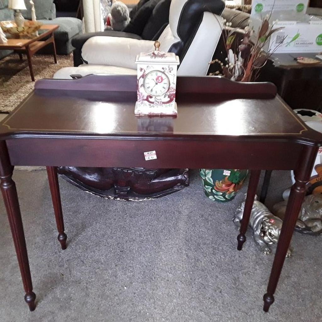 SALE - Was £40 NOW £32.

This vintage mahogany style console table is in good all-round used condition. There are signs of use where the gold inlay on the top is a bit sparse in places...

35 inches wide x 16 inches deep x 28 inches high.

Our second hand furniture mill shop is LOW COST MOVES, at St Paul's trading estate, Copley Mill, off Huddersfield Road, Stalybridge SK15 3DN... Delivery available for an extra charge.

There are some large metal gates next to St Paul's church... Go through them, bear immediate left and we are at the bottom of the slope, up from the red steps...

If you are interested in this or any other item, please contact me on 07734 330574, or on the shop 0161 879 9365...Many thanks, Helen.

We are OPEN Monday to Friday from 10 am - 5 pm and Saturday 10 am - 3.30 pm... CLOSED Sundays. CLOSED Bank Holiday long weekends...