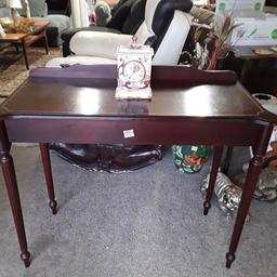 SALE - Was £40 NOW £32.

This vintage mahogany style console table is in good all-round used condition. There are signs of use where the gold inlay on the top is a bit sparse in places...

35 inches wide x 16 inches deep x 28 inches high.

Our second hand furniture mill shop is LOW COST MOVES, at St Paul's trading estate, Copley Mill, off Huddersfield Road, Stalybridge SK15 3DN... Delivery available for an extra charge.

There are some large metal gates next to St Paul's church... Go through them, bear immediate left and we are at the bottom of the slope, up from the red steps... 

If you are interested in this or any other item, please contact me on 07734 330574, or on the shop 0161 879 9365...Many thanks, Helen. 

We are OPEN Monday to Friday from 10 am - 5 pm and Saturday 10 am - 3.30 pm... CLOSED Sundays.  CLOSED Bank Holiday long weekends...