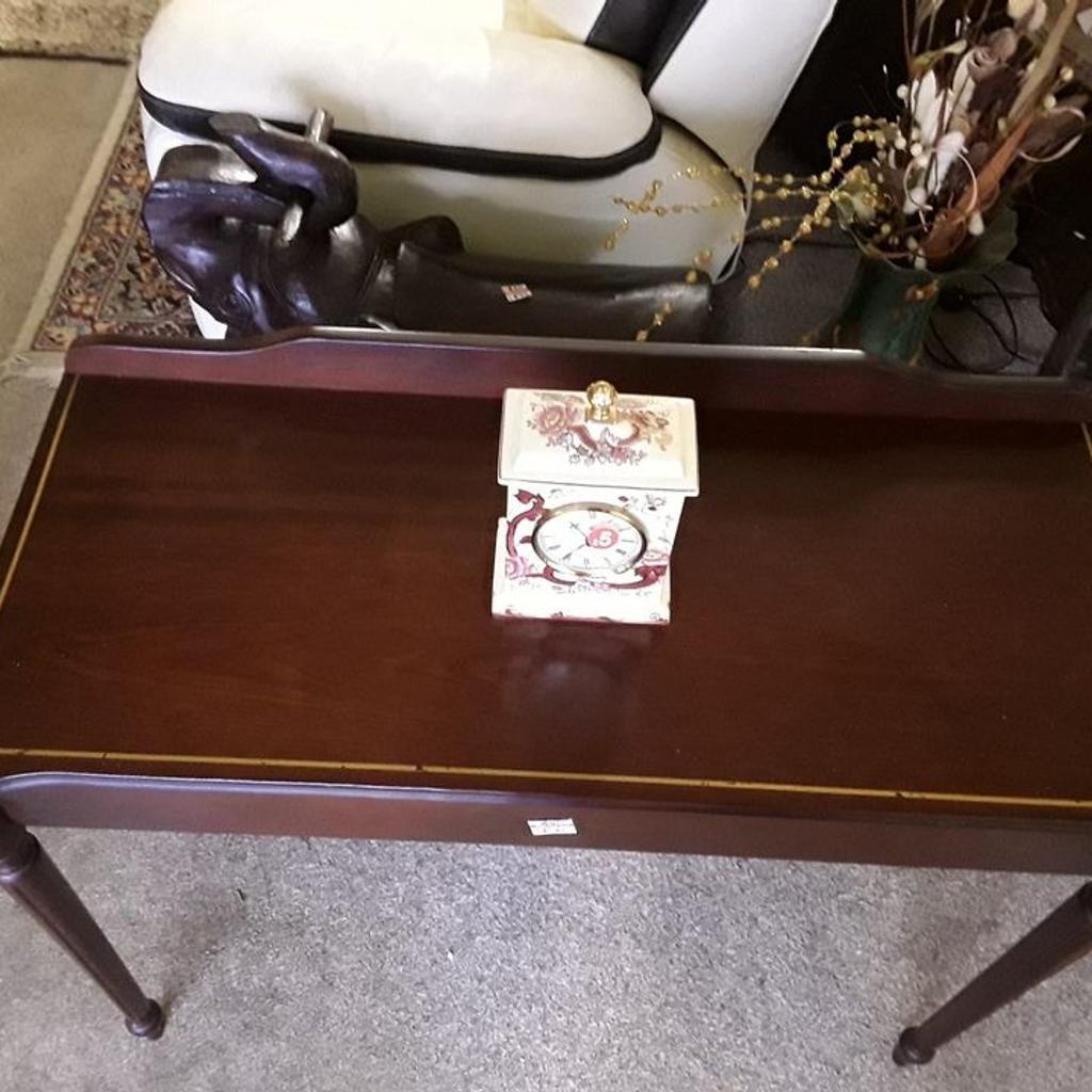 SALE - Was £40 NOW £32.

This vintage mahogany style console table is in good all-round used condition. There are signs of use where the gold inlay on the top is a bit sparse in places...

35 inches wide x 16 inches deep x 28 inches high.

Our second hand furniture mill shop is LOW COST MOVES, at St Paul's trading estate, Copley Mill, off Huddersfield Road, Stalybridge SK15 3DN... Delivery available for an extra charge.

There are some large metal gates next to St Paul's church... Go through them, bear immediate left and we are at the bottom of the slope, up from the red steps...

If you are interested in this or any other item, please contact me on 07734 330574, or on the shop 0161 879 9365...Many thanks, Helen.

We are OPEN Monday to Friday from 10 am - 5 pm and Saturday 10 am - 3.30 pm... CLOSED Sundays. CLOSED Bank Holiday long weekends...