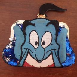 Irregular Choice Aladin Genie purse. in fair condition, with some wear and tear, the back picture is worn in a couple of places, and the edging to his hair is coming away, but can easily be glued back on again. The clasp still works really well and is very secure. He did originally have an earring, but that fell off and was lost, it is easily replaced with a normal small hoop earring as the hole is still there (as photographed).
From a smoke free home, with a cat.