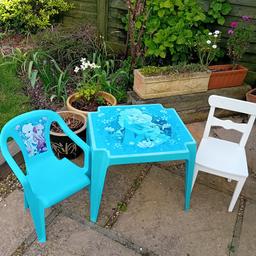 table a little faded due to the sun
plastic chair and a wooden chair
no longer needed