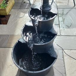 Large 3 Tier barrel cascading water Feature 
Good used condition. 
Height is 100cms.
Largest bottom barrel is 55cm.
Middle Barrel is 40cm
Top Barrel is 30cm.
pump works fine, Adjustable water speed.
The barrels have dipped slightly due to the weight of the water.
You may find minor scuffs etc but remember it's been outside for a number of years.
colour is black and bronze effect.