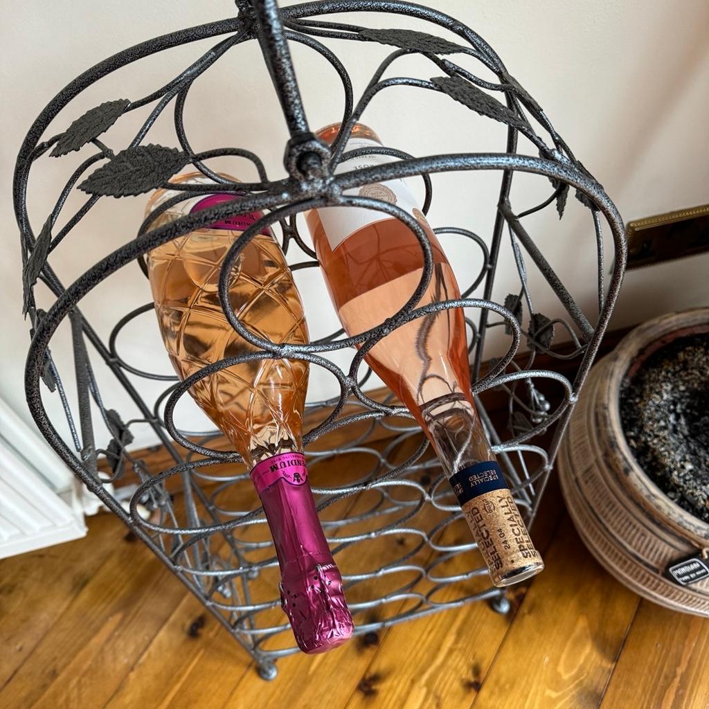 Pretty Solid Steel Wine rack. Leaf design down the sides. Top handle for easy movement. Excellent condition. Holds 18 bottles. Pick up only. No time wasters or scammers