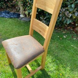 Heavy Solid Oak dining chairs. Padded cushion seat. Can sell separately if required.