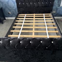 Double bed with high head board and smaller toe board. Black velour with clear plastic jewels. Latted wood base in good condition .