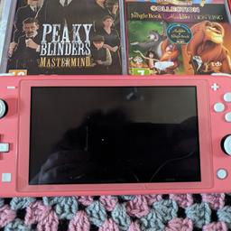 coral pink nintendo switch lite for sale. the crack visible in the photos is just on the screen protector that needs replacing. comes with numskul unicorn case for protection. come as a package deal or games can be sold separately.