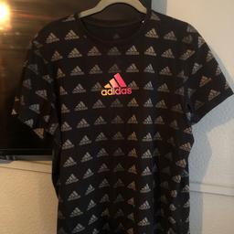 Adidas t shirt 
Girls size large
Grey logo all over with pink/ purple in centre 
Good condition
