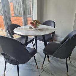Beautiful marble effect table and four grey comfortabl chairs
