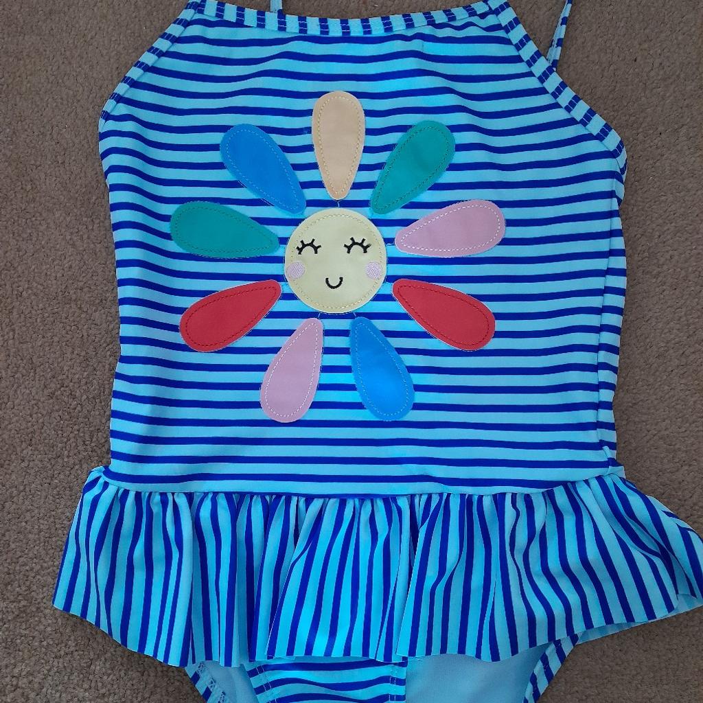 Selection of girls' swimwear. Include 3 bikinis by M&S, 1 by Next in first image and 2 by Primark in last image.. Encanto and Blue striped swimsuits are by George. All aged 6-7 years. Excellent condition