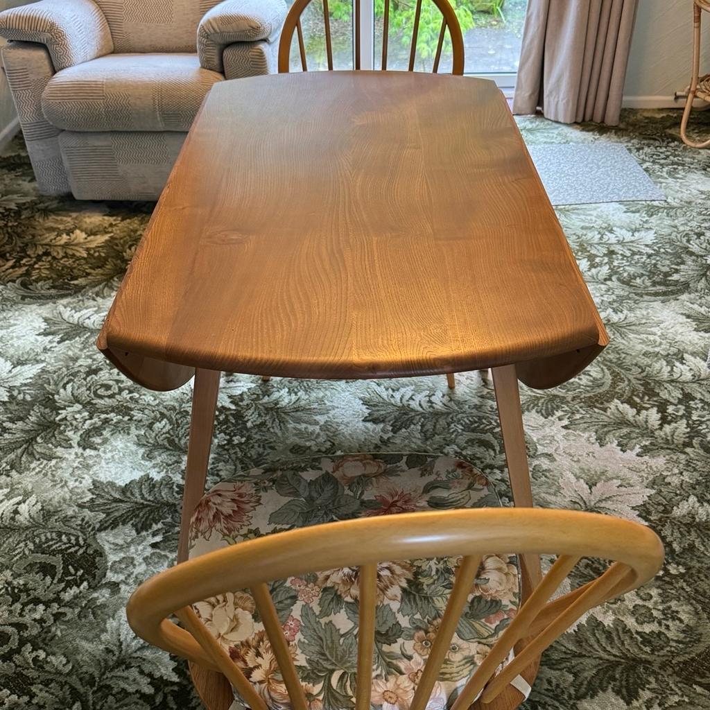 Ercol make - Dining room table (extendable via wings) and 2 chairs. Chairs include original cushions, as shown.

Excellent condition.

From a pet and smoke free home.

All reasonable offers considered.

Collection only.