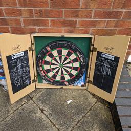 good fun dart board inside a cabinet,with black board either side for scoring.
Phil Taylor aproved