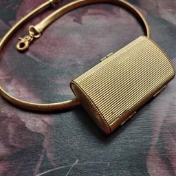 Belt size 32". Metal belt with lobster clasp fastening. Small rectangular bag with texture and clasp fastening. ~2.8in (7cm) height x 4.6in (11.7cm) length x 1.2 in (3cm) width.
Great item to keep a Lady's purse essentials: credit card, lipstick, klenex and gum with you at all times without having to carry a bag. 
Sold as pictured.