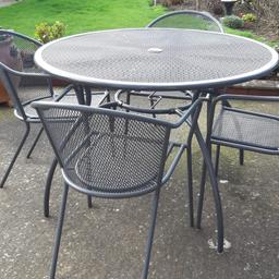 Revamp your garden with our elegant, sturdy furniture set. Featuring a metal table incorporating brolly hole, with a sleek gray-green finish and four weather-resistant chairs, all freshly repainted to high standard. From a pet-free, smoke-free home, this set rivals new ones costing over £620. We invite sensible offers, pick-up only, or you can arrange a courier. Transform your outdoor space into a haven of relaxation—contact us to make this exquisite set yours.