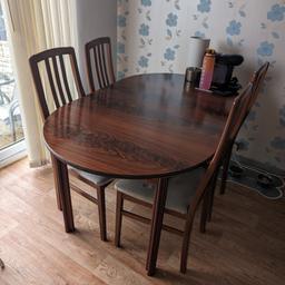 wooden table and four chairs. Table can extend to be made bigger.