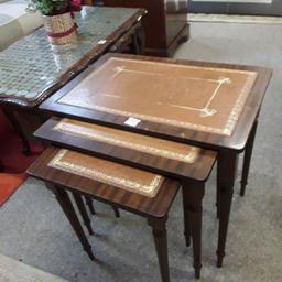 SALE - Was £35 NOW £28.

This vintage nest of wooden tables with brown leather tops are in good overall used condition. Signs of use due to age...

Largest table - 22 inches wide x 15 inches deep x 20 inches high.
Medium - 18 inches wide x 12 inches deep x 19 inches high.
Smallest - 14 inches wide x 10 inches deep x 18 inches high.

Our second hand furniture mill shop is LOW COST MOVES, at St Paul's trading estate, Copley Mill, off Huddersfield Road, Stalybridge SK15 3DN... Delivery available for an extra charge.

There are some large metal gates next to St Paul's church... Go through them, bear immediate left and we are at the bottom of the slope, up from the red steps... 

If you are interested in this or any other item, please contact me on 07734 330574, or on the shop 0161 879 9365...Many thanks, Helen. 

We are OPEN Monday to Friday from 10 am - 5 pm and Saturday 10 am - 3.30 pm... CLOSED Sundays.  CLOSED Bank Holiday long weekends...